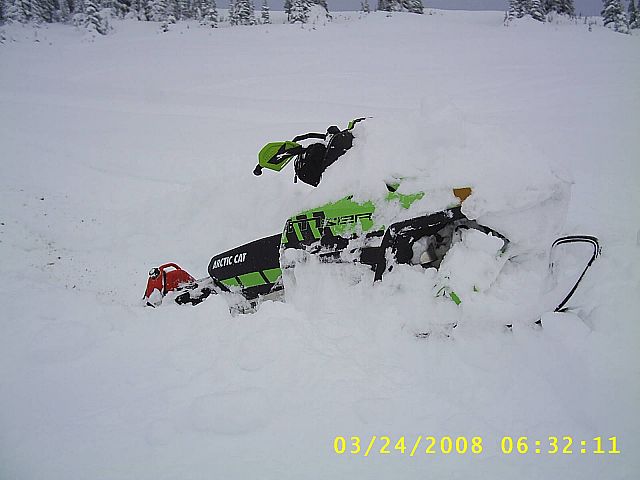 stuck .....used the roll-over move-clear snow away from low side and flip sled over it naturally points downhill-drive it out