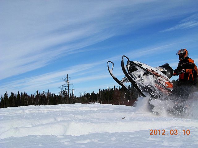 Going for some air time along the trail from Hudson Bay to Carrot River