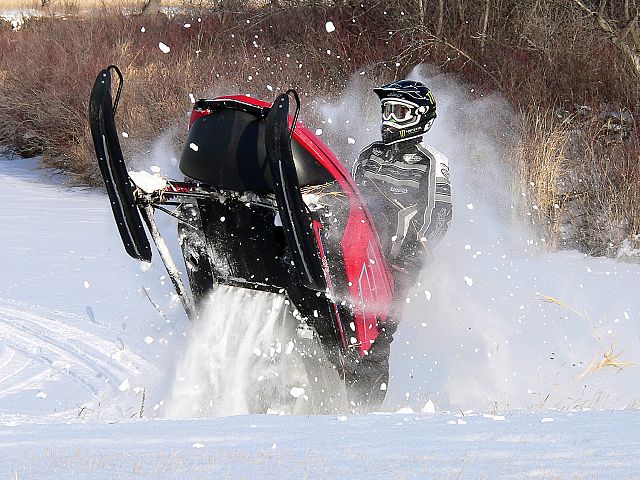 A friends son blasts through a snowy embankment  on a ride along the Moose Jaw River.