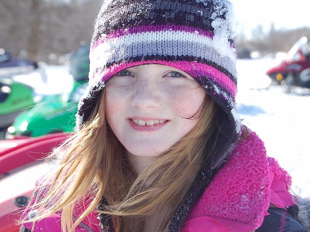 Snowmobiling, a weiner roast and tobogganning with Nana, Papa and Dad make for a big happy smile.