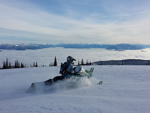 sitting on top of the world watching my girlfriend shred the clouds 