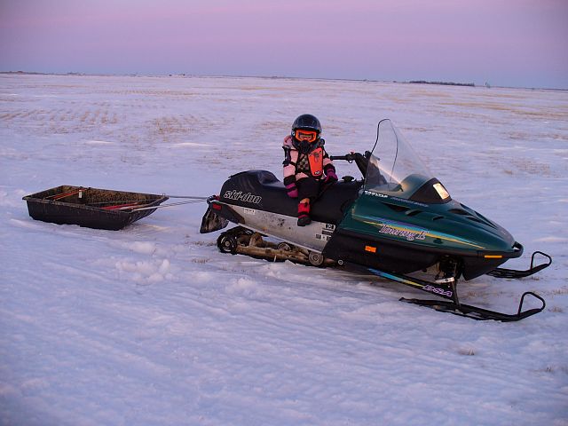 Picking up the snowmobile trail markers 
