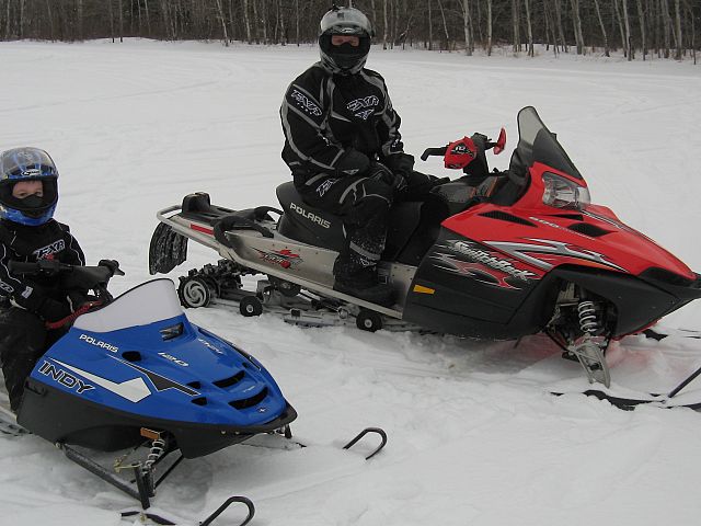 Father and 4 year old son both having a great day enjoying some sledding. 