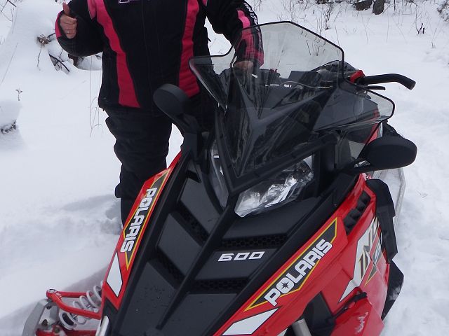Someone likes their new snowmobile.