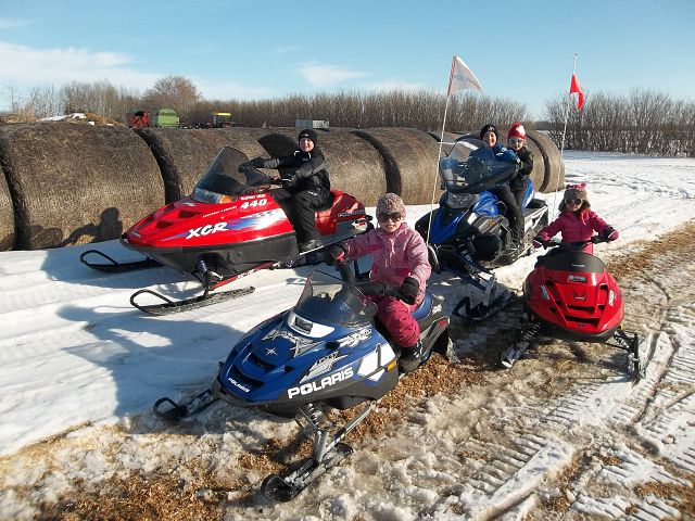 All 5 Grandkids sledding to the farm!