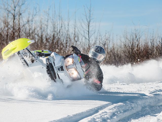My dad leaning over his Freeride in some nice snow.