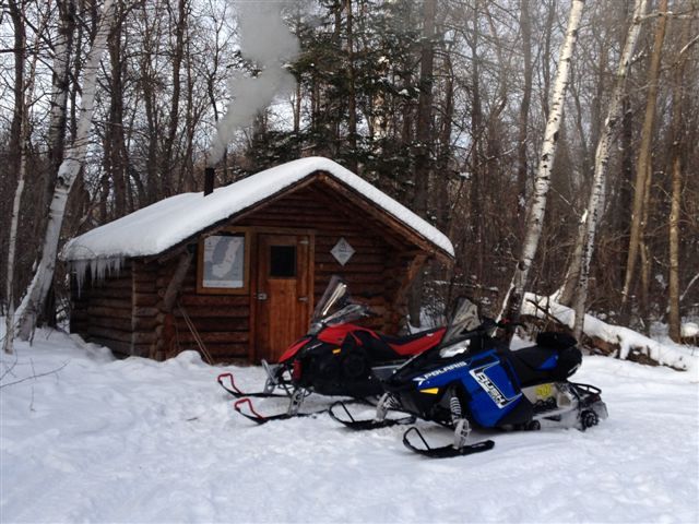 This is my favorite picture with the sleds outside the shack with the smoke coming out.  Great Shack!