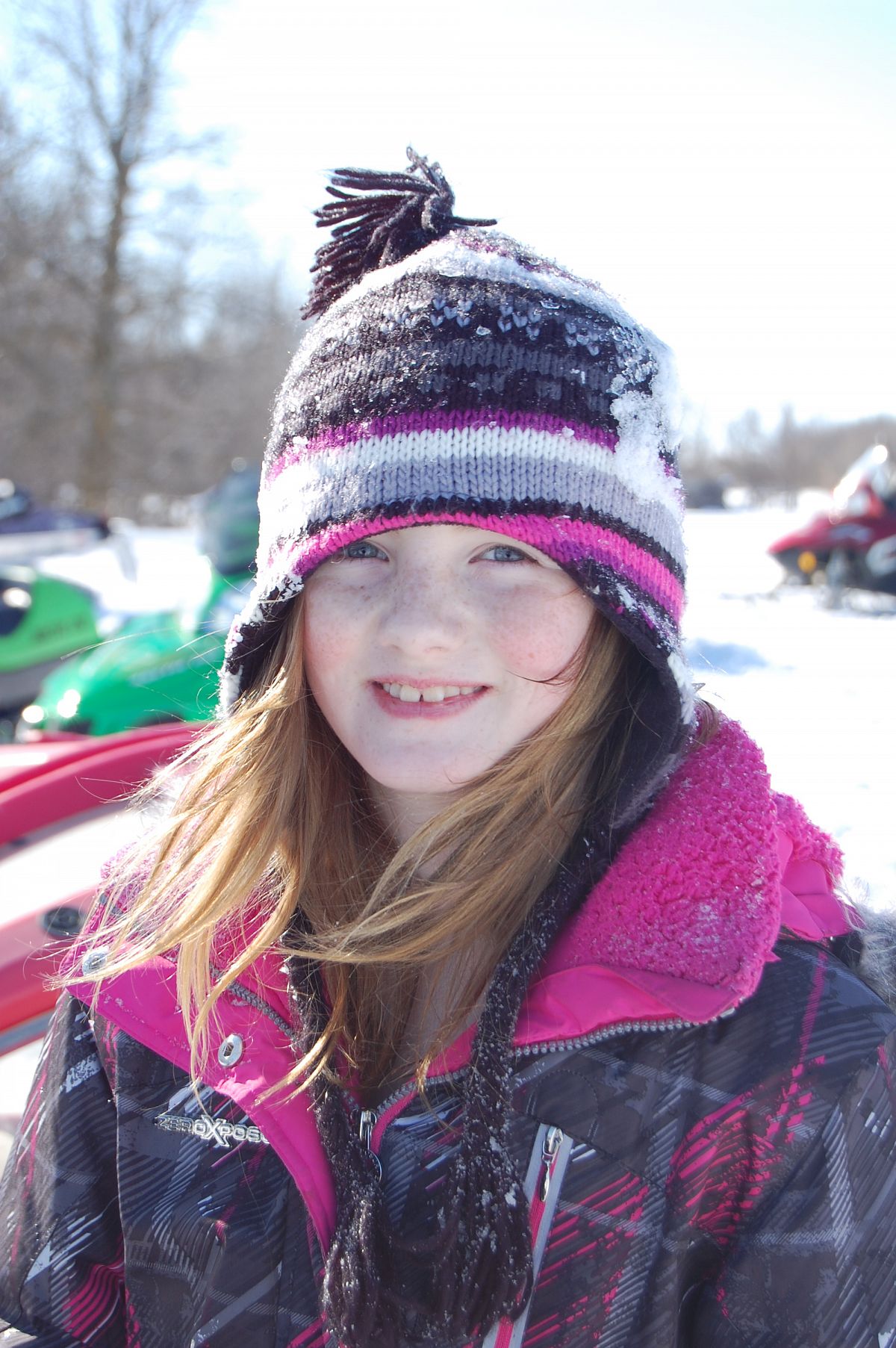 Snowmobiling, a weiner roast and tobogganning with Nana, Papa and Dad make for a big happy smile.