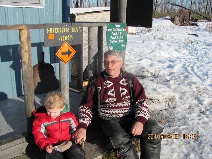 My son Brody age 2 1/2 at this time.   He loves going for snowmobile rides with his grandpa from Hudson Bay!  Here they are at Brody's favorite place...Larry's place warm up shack.  This photo was taken in  march 2010 