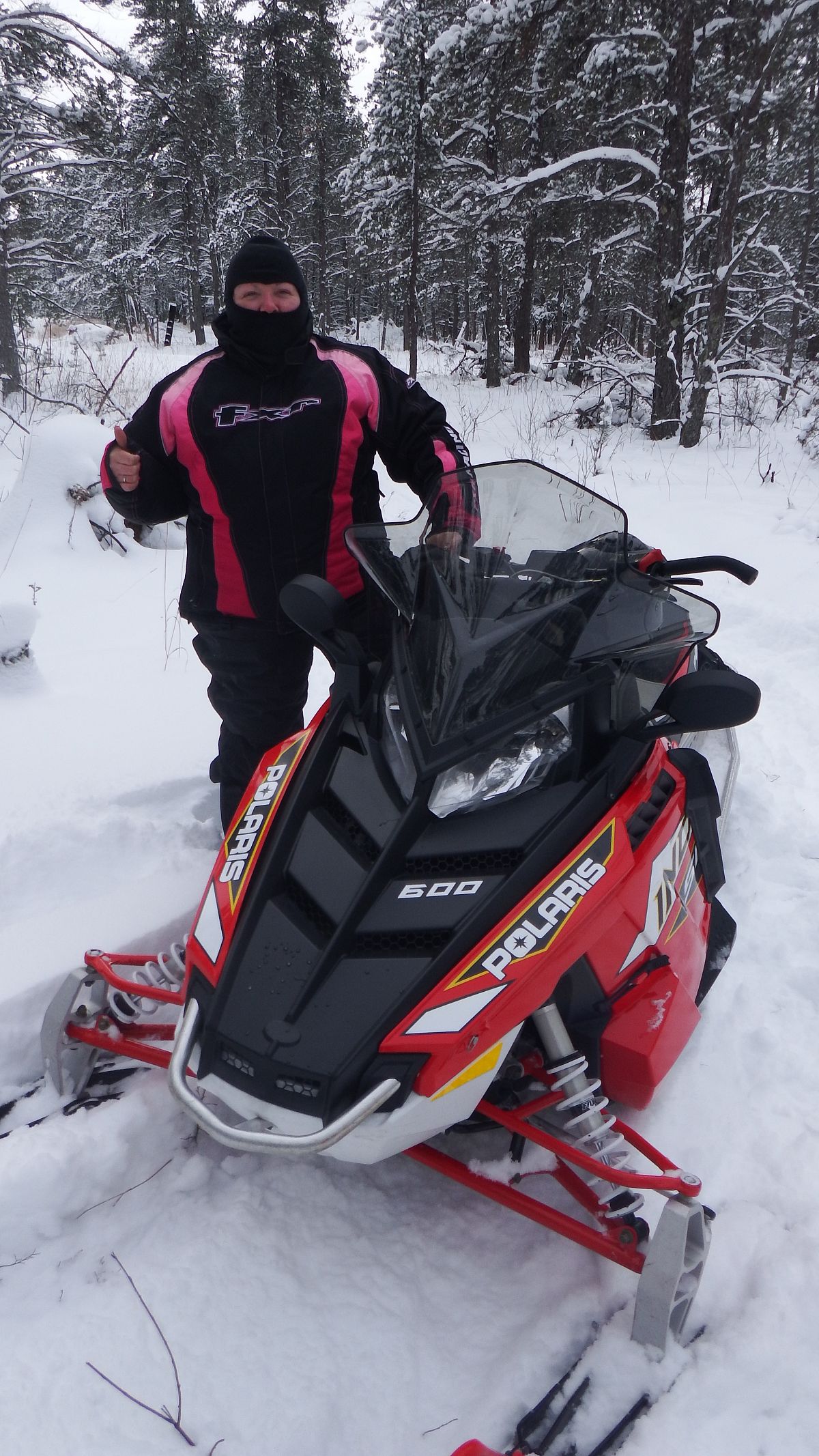 Someone likes their new snowmobile.