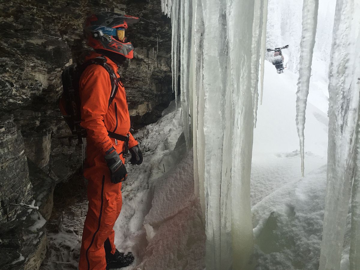 Keith Curtis taking a break in one of BCs ice waterfalls while on a Timbersled adventure 