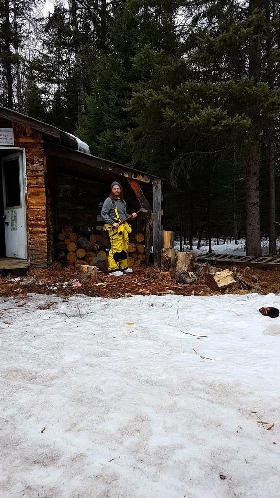 Local handsome lumberjack splitting wood to leave for the next group of riders to enjoy.  
